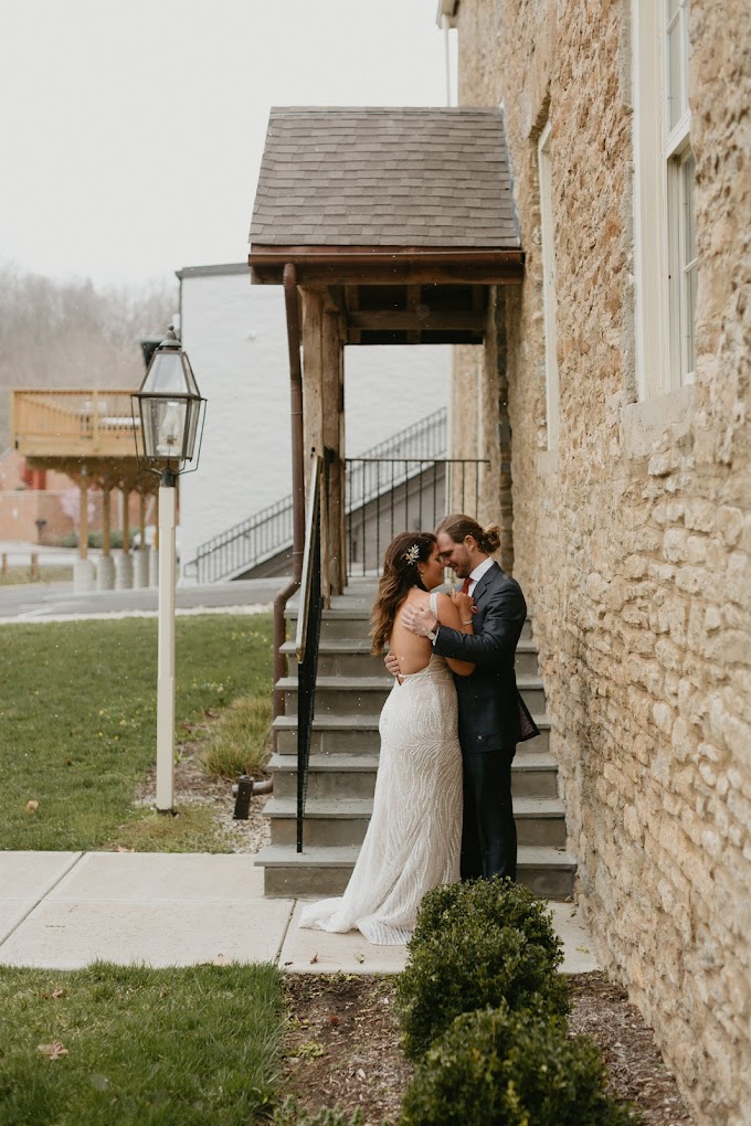 Bride and Groom at Little Miami Brewing A bride and groom share an intimate moment near a rustic stone building.