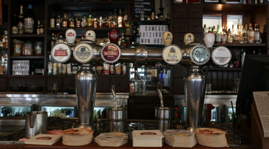 A bar counter showcasing beer taps, featuring popular brands, representing Cincinnati's brewing history and its vibrant beer culture.